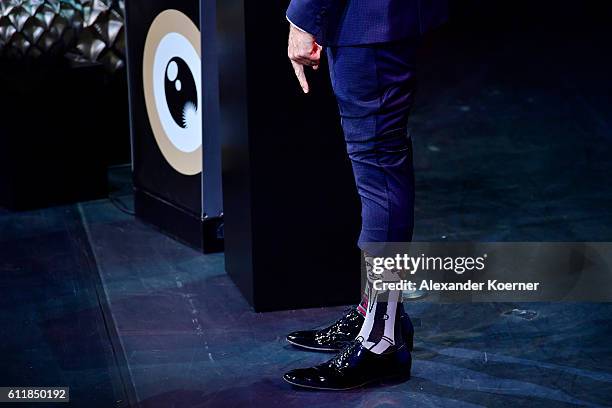 Moderator Steven Gaetjen shows his socks on stage during the Award Night Ceremony during the 12th Zurich Film Festival on October 1, 2016 in Zurich,...