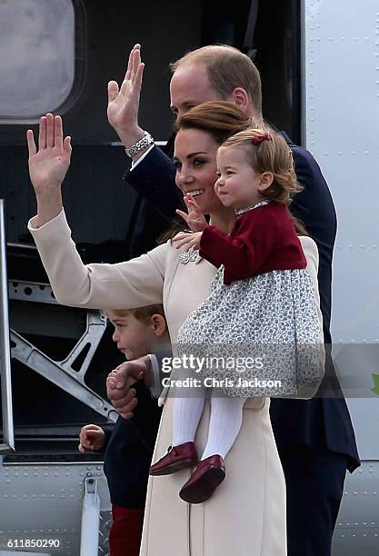 Prince William, Duke of Cambridge, Prince George of Cambridge, Catherine, Duchess of Cambridge and Princess Charlotte wave as they leave from...