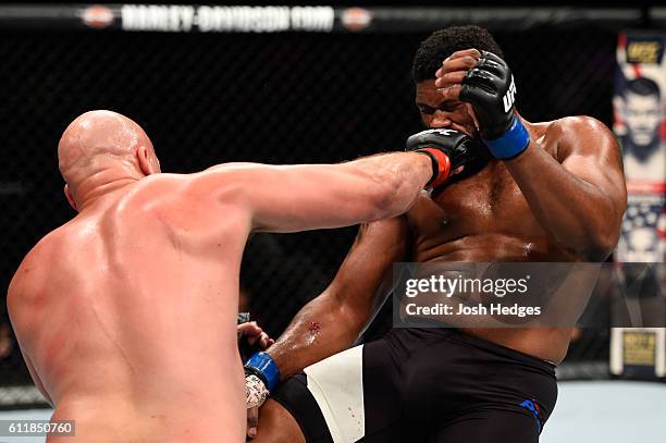 Cody East punches Curtis Blaydes in their heavyweight bout during the UFC Fight Night event at the Moda Center on October 1, 2016 in Portland, Oregon.