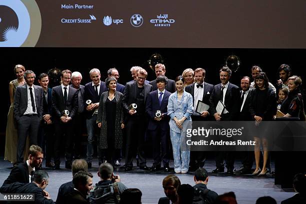 Award winners and jury members pose for photographers on stage during the Award Night Ceremony during the 12th Zurich Film Festival on October 1,...