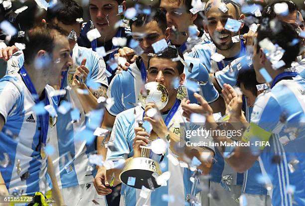 Cristian Borruto of Argentina holds the trophy during the FIFA Futsal World Cup Final match between Russia and Argentina at the Coliseo el Pueblo...