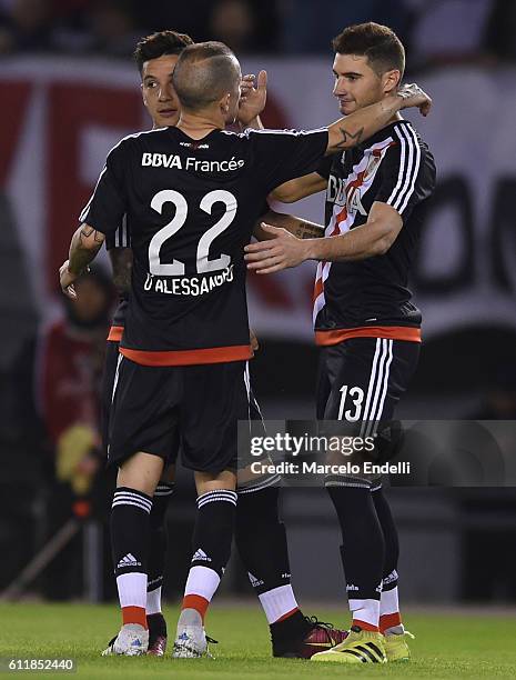 Lucas Alario of River Plate celebrates with teammates Sebastian Driussi and Andres D'Alessandro after scoring the second goal of his team during a...