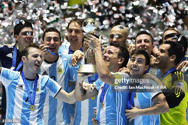 Fernando Wilhelm of Argentina holds the trophy during the FIFA Futsal World Cup Final match between Russia and Argentina at the Coliseo el Pueblo...