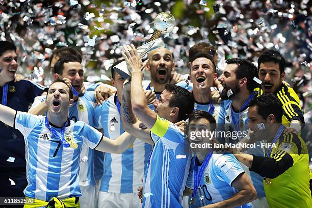 Fernando Wilhelm of Argentina holds the trophy during the FIFA Futsal World Cup Final match between Russia and Argentina at the Coliseo el Pueblo...