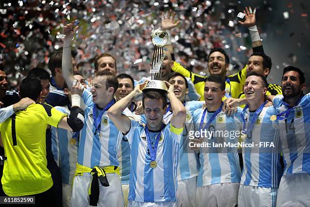 Fernando Wilhelm of Argentina holds the trophy during the FIFA Futsal World Cup Final match between Russia and Argentina at the Coliseo el Pueblo...