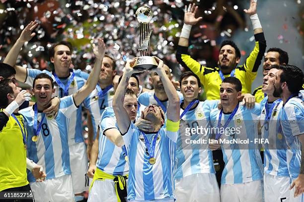 Fernando Wilhelm of Argentina holds the trophy during the FIFA Futsal World Cup Final match between Russia and Argentina at the Coliseo el Pueblo...
