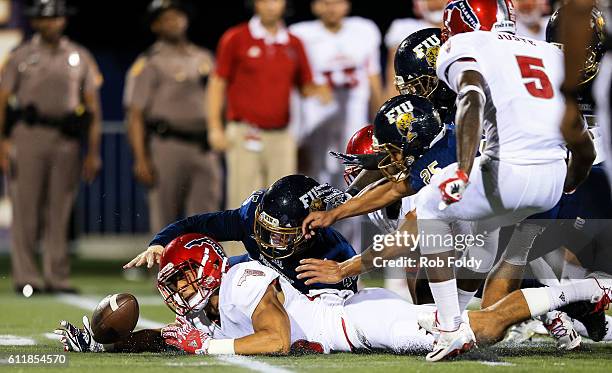 Tevin Homer of the Florida Atlantic Owls recovers a loose ball during the first half of the game against the FIU Panthers at FIU Stadium on October...