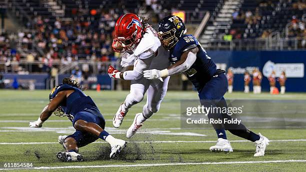 Gregory Howell Jr. #9 of the Florida Atlantic Owls in action against Treyvon Williams of the FIU Panthers during the first half of the game at FIU...
