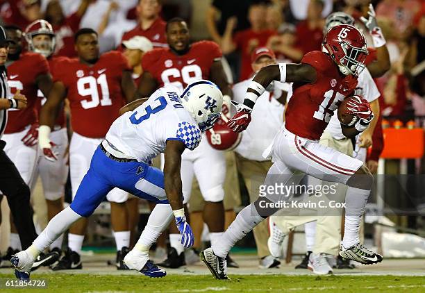 Ronnie Harrison of the Alabama Crimson Tide breaks a tackle by Jojo Kemp of the Kentucky Wildcats as he returns a fumble for a touchdown at...