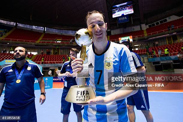 Leandro Cuzzolino of Argentina poses with the trophy during the FIFA Futsal World Cup final between Russia and Argentina at Coliseo el Pueblo on...