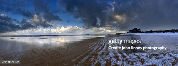 moody bamburgh castle in the snow. northumberland. uk. europe. - northumberland foto e immagini stock