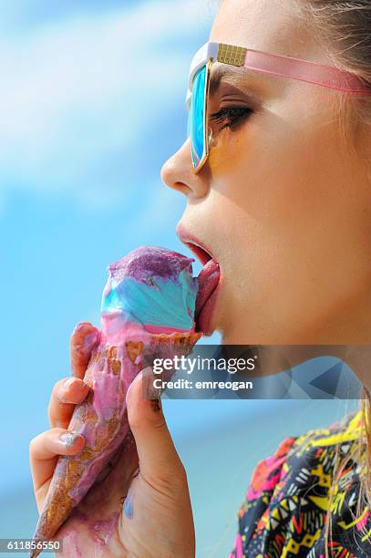 young real woman eating ice cream - women licking women stock pictures, royalty-free photos & images