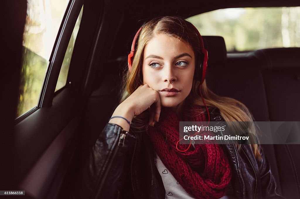 Teenage girl on a road trip with car