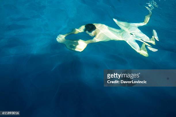 the metamorphosis of the man in water - avant garde bildbanksfoton och bilder