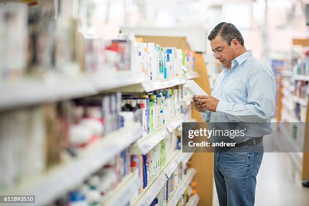 man shopping at the pharmacy - pharmacy customer stock pictures, royalty-free photos & images