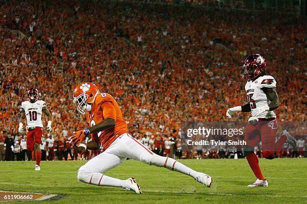 Deon Cain of the Clemson Tigers catches a second quarter touchdown reception under pressure from Trumaine Washington of the Louisville Cardinals at...