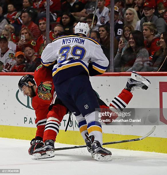 Eric Nystrom of the St. Louis Blues dumps Michal Kempny of the Chicago Blackhawks during a preseason game at the United Center on October 1, 2016 in...