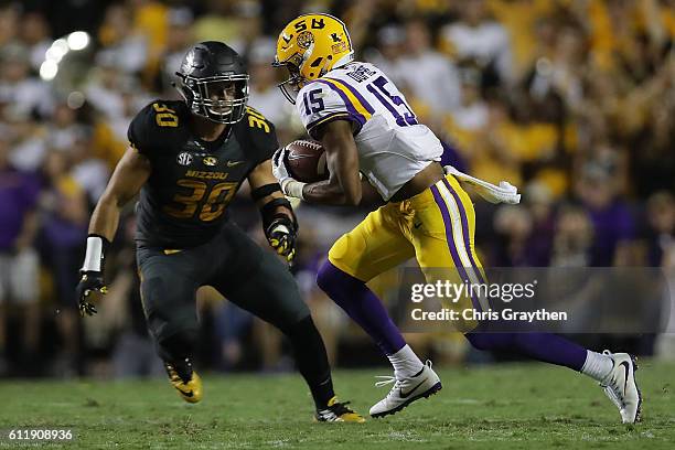 Malachi Dupre of the LSU Tigers avoids a tackle against the Missouri Tigers at Tiger Stadium on October 1, 2016 in Baton Rouge, Louisiana.