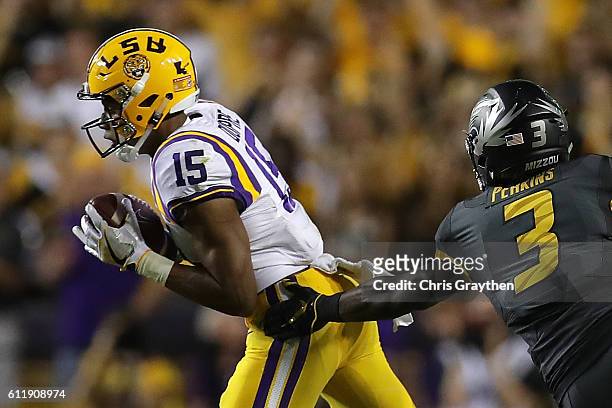 Malachi Dupre of the LSU Tigers avoids a tackle against the Missouri Tigers at Tiger Stadium on October 1, 2016 in Baton Rouge, Louisiana.