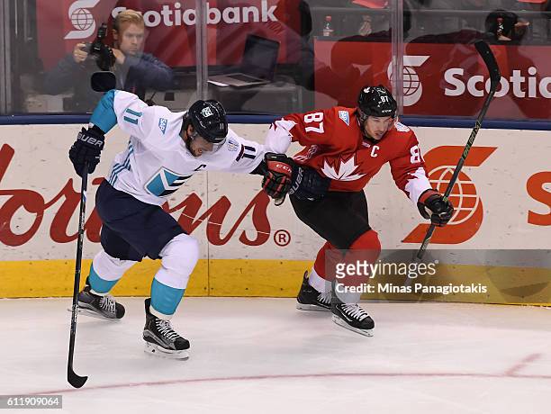 Anze Kopitar of Team Europe battles for position with Sidney Crosby of Team Canada during Game One of the World Cup of Hockey final series at the Air...
