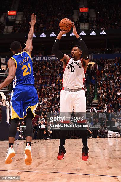 Jared Sullinger of the Toronto Raptors shoots against Ian Clark of the Golden State Warriors during a preseason game on October 1, 2016 at Rogers...