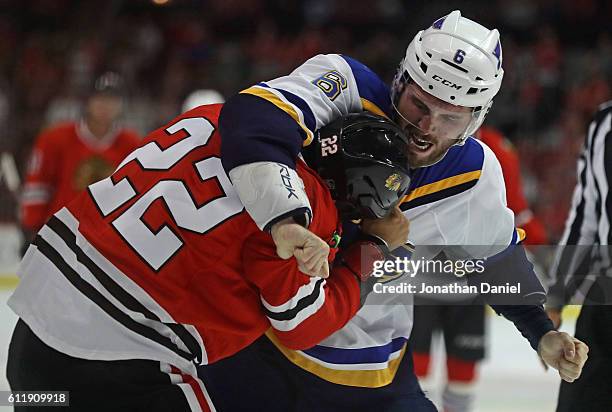 Joel Edmundson of the St. Louis Blues and Jordin Tootoo of the Chicago Blackhawks fight in the second period during a preseason game at the United...