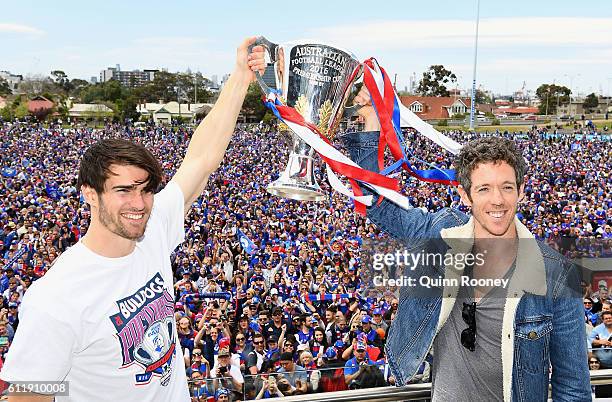 Easton Wood and Robert Murphy of the Bulldogs pose with the trophy during the Western Bulldogs AFL Grand Final celebrations at Whitten Oval on...