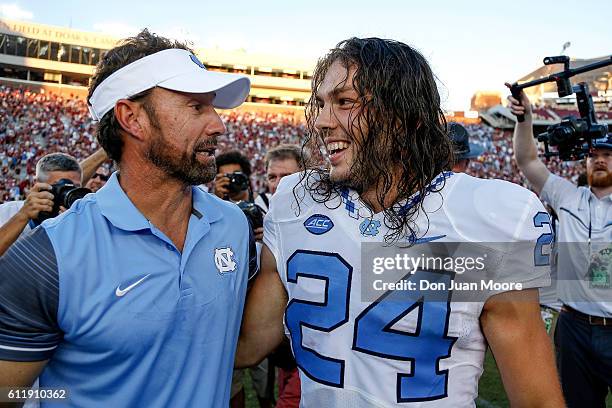 Head Coach Larry Fedora celebrates with Kicker Nick Weiler of the North Carolina Tar Heels for hitting a 54 yard game winning field goal the game...