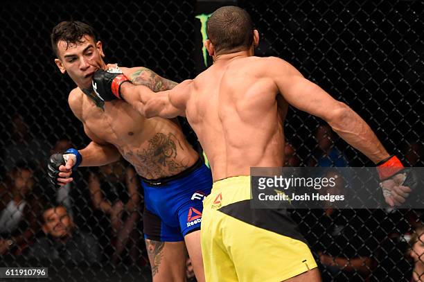 Hacran Dias of Brazil punches Andre Fili in their featherweight bout during the UFC Fight Night event at the Moda Center on October 1, 2016 in...