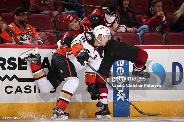 Ryan Garbutt of the Anaheim Ducks lays a body check onto Nick Merkley of the Arizona Coyotes during the second period of the preseason NHL game at...