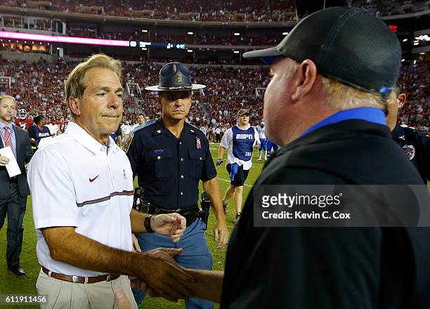 Head coach Nick Saban of the Alabama Crimson Tide shakes hands with head coach Mark Stoops of the Kentucky Wildcats after their 34-6 win at...