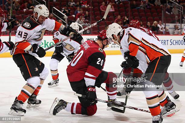 Dylan Strome of the Arizona Coyotes battles Corey Tropp of the Anaheim Ducks for a loose puck during the second period of the preseason NHL game at...