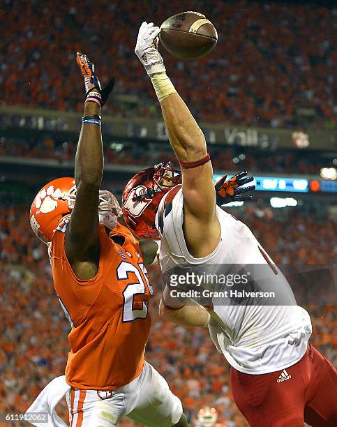 Cordrea Tankersley of the Clemson Tigers defends a pass to Cole Hikutini of the Louisville Cardinals during the second quarter at Memorial Stadium on...