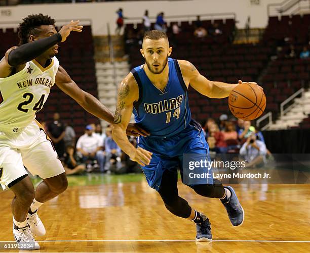 Keith Hornsby of the Dallas Mavericks drives to the basket against Buddy Hield of the New Orleans Pelicans during a preseason game on October 1, 2016...