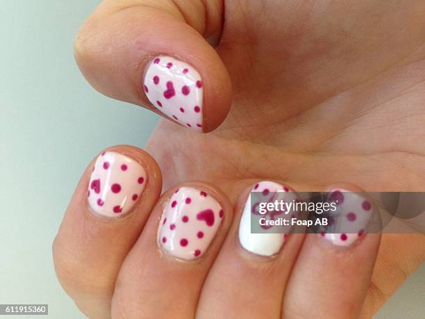 girl hand with nail art - heart nail art stock pictures, royalty-free photos & images