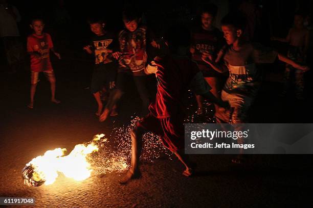 Indonesian Muslims seen playing a soccer game using a fireball made from a coconut from a palm tree soaked in kerosene as they take part in the...