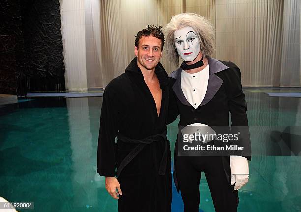 Olympian Ryan Lochte and Benedikt Negro as the "O by Cirque du Soleil" character Le Vieux pose next to the pool at the "O" theater during a rehearsal...