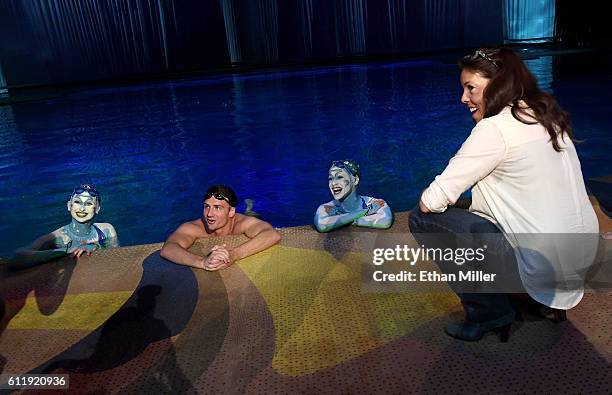 By Cirque du Soleil" artistic director Sandi Croft looks on as Olympian Ryan Lochte swims in the pool at the "O" theater with "O" performers Nayara...