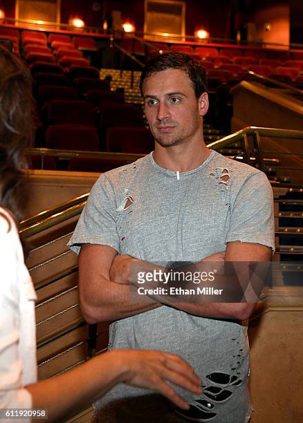 Olympian Ryan Lochte stands in the "O" theater as he and dancer Cheryl Burke arrive at a rehearsal for their "Dancing with the Stars" performance...
