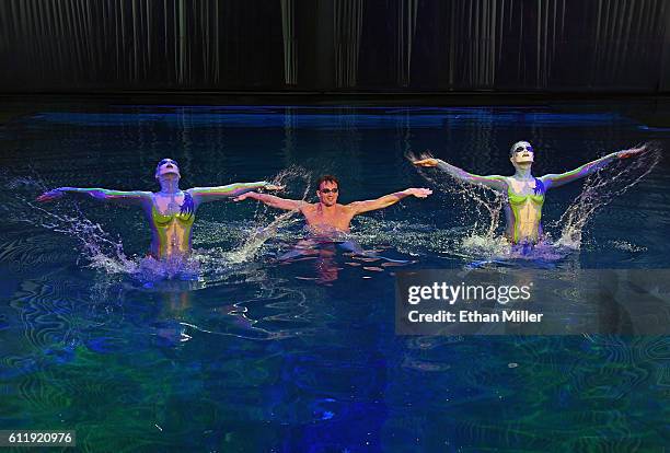 Olympian Ryan Lochte performs in the pool at the "O" theater with "O by Cirque du Soleil" performers Nayara Figueira and Christina Jones as Lochte...