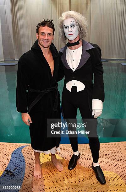 Olympian Ryan Lochte and Benedikt Negro as the "O by Cirque du Soleil" character Le Vieux pose next to the pool at the "O" theater during a rehearsal...