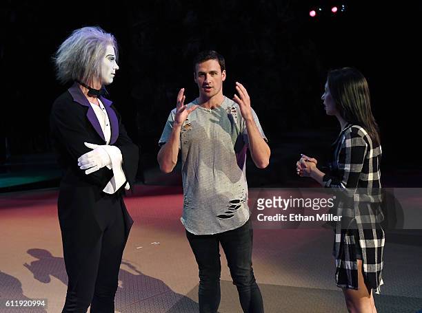 By Cirque du Soleil" performer Benedikt Negro as the character Le Vieux talks with Olympian Ryan Lochte and dancer Cheryl Burke as they rehearse for...