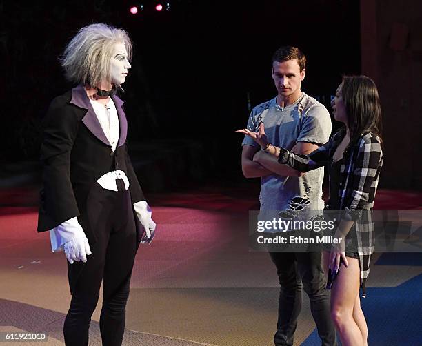 By Cirque du Soleil" performer Benedikt Negro as the character Le Vieux talks with Olympian Ryan Lochte and dancer Cheryl Burke as they rehearse for...