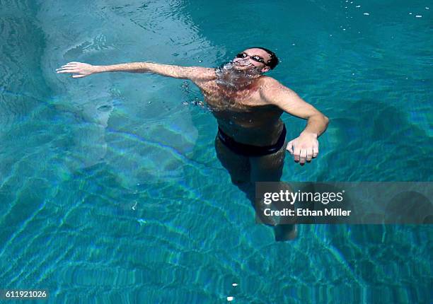 Olympian Ryan Lochte swims in the pool at the "O" theater as he and dancer Cheryl Burke rehearse for their "Dancing with the Stars" performance with...