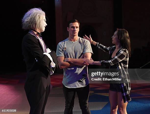 By Cirque du Soleil" performer Benedikt Negro as the character Le Vieux talks with Olympian Ryan Lochte and dancer Cheryl Burke as they rehearse for...