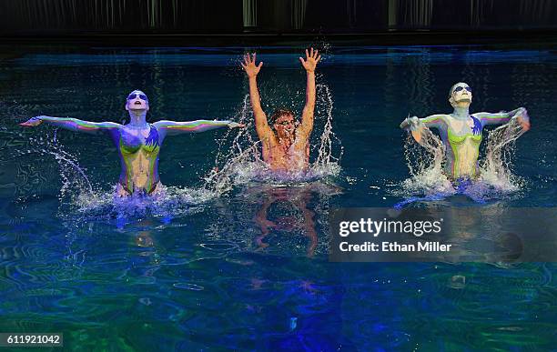 Olympian Ryan Lochte performs in the pool at the "O" theater with "O by Cirque du Soleil" performers Nayara Figueira and Christina Jones as Lochte...