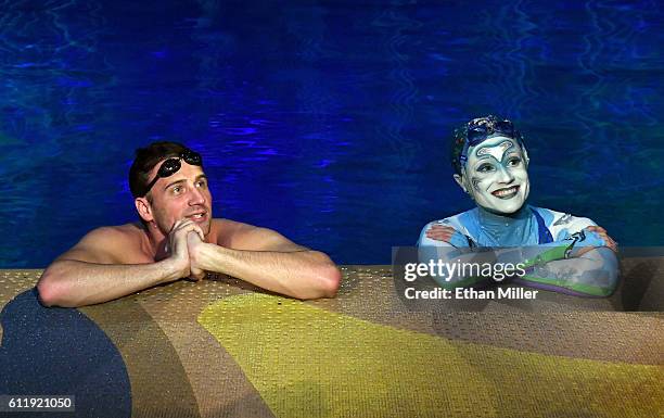 Olympian Ryan Lochte swims in the pool at the "O" theater with "O by Cirque du Soleil" performer Christina Jones as Lochte and dancer Cheryl Burke...