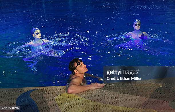 Olympian Ryan Lochte swims in the pool at the "O" theater with "O by Cirque du Soleil" performers Nayara Figueira and Christina Jones as Lochte and...