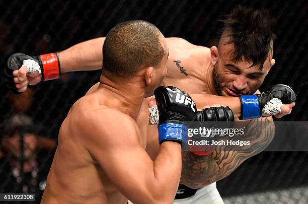 John Dodson punches John Lineker of Brazil in their bantamweight bout during the UFC Fight Night event at the Moda Center on October 1, 2016 in...