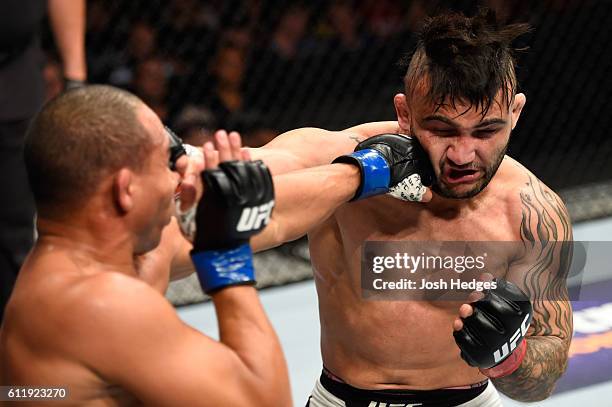 John Dodson punches John Lineker of Brazil in their bantamweight bout during the UFC Fight Night event at the Moda Center on October 1, 2016 in...